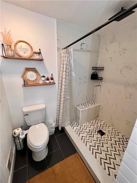 124 Dockside Downs Dr, Woodstock, GA 30189 - bathroom with a shower stall and tile patterned floors