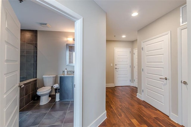 bathroom with wood-type flooring and toilet