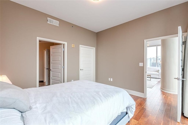 bedroom with hardwood / wood-style floors