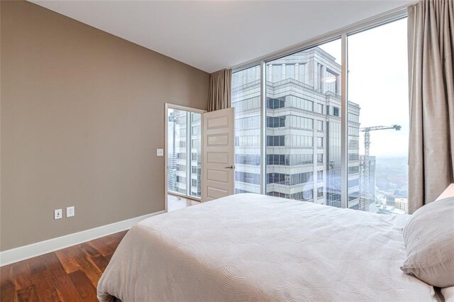 bedroom with dark hardwood / wood-style flooring