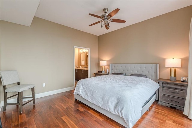 bedroom with connected bathroom, ceiling fan, and hardwood / wood-style floors