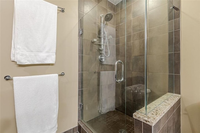 bathroom with a shower with door