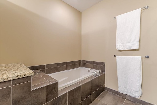 bathroom with tile patterned floors and tiled tub