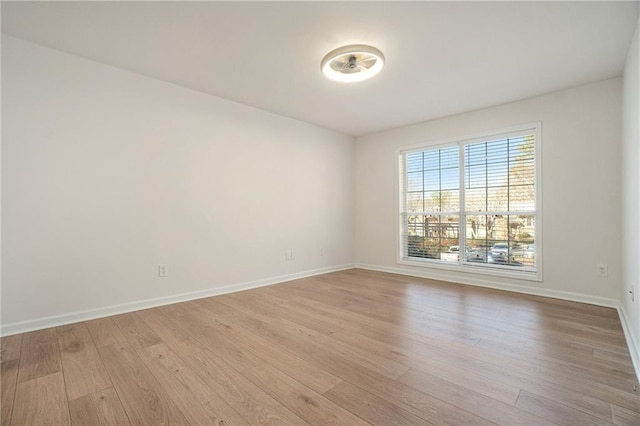 empty room with light hardwood / wood-style flooring