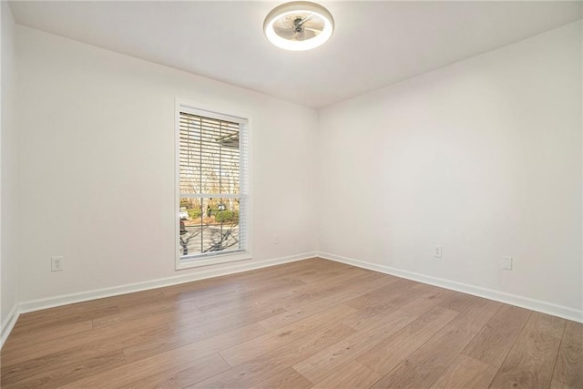 empty room with light hardwood / wood-style flooring