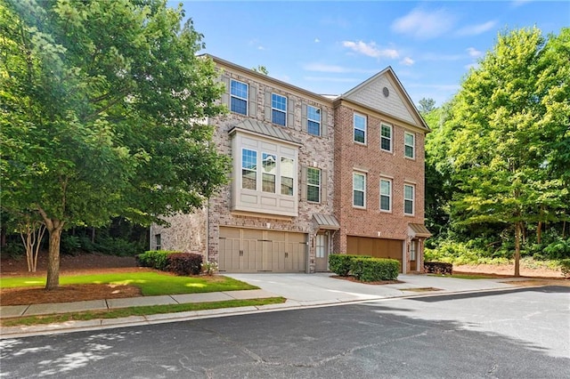 5440 Willow Oak Dr, Norcross, GA 30092 - view of property featuring concrete driveway, an attached garage, and brick siding