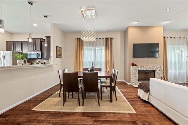 5440 Willow Oak Dr, Norcross, GA 30092 - dining area featuring plenty of natural light, dark wood-style floors, recessed lighting, and a tiled fireplace