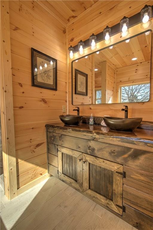 bathroom featuring vanity, wood ceiling, and wooden walls