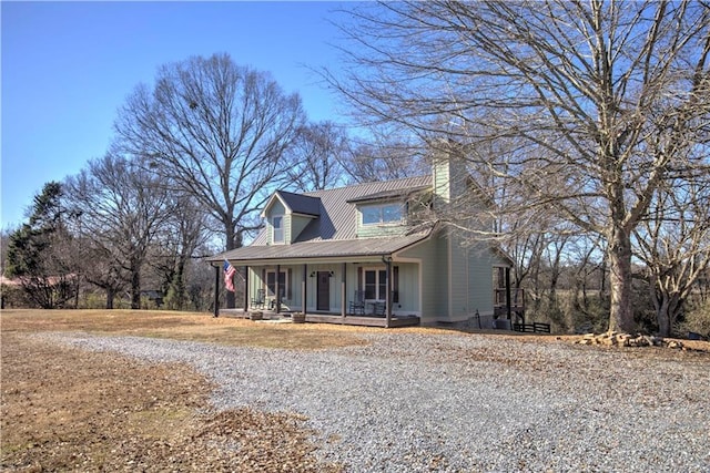 cape cod-style house featuring covered porch