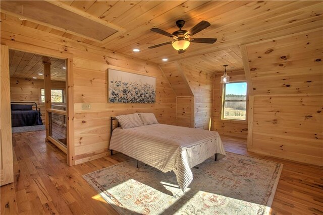 bedroom with ceiling fan, wood ceiling, multiple windows, and light hardwood / wood-style flooring