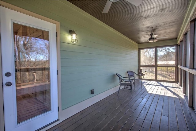 unfurnished sunroom featuring ceiling fan and wooden ceiling