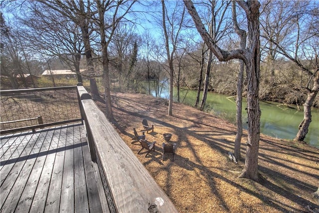 wooden deck featuring a water view