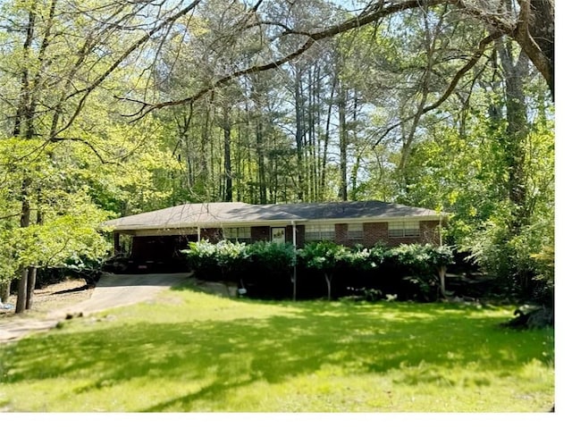 single story home with a carport, driveway, a front lawn, and brick siding