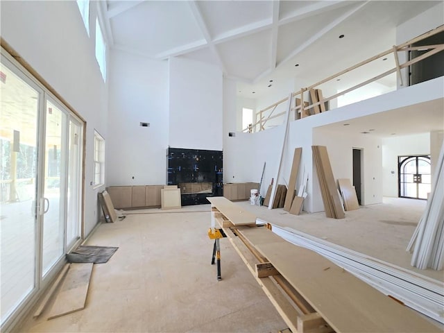 interior space with a high ceiling, coffered ceiling, and french doors