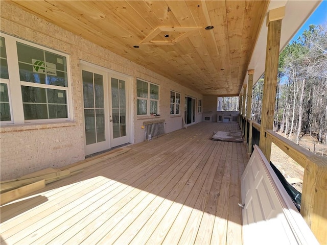 wooden deck featuring french doors and radiator