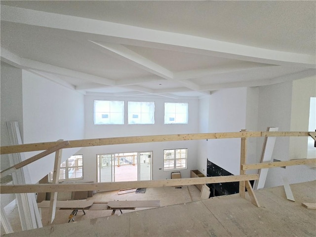 empty room featuring coffered ceiling and beam ceiling