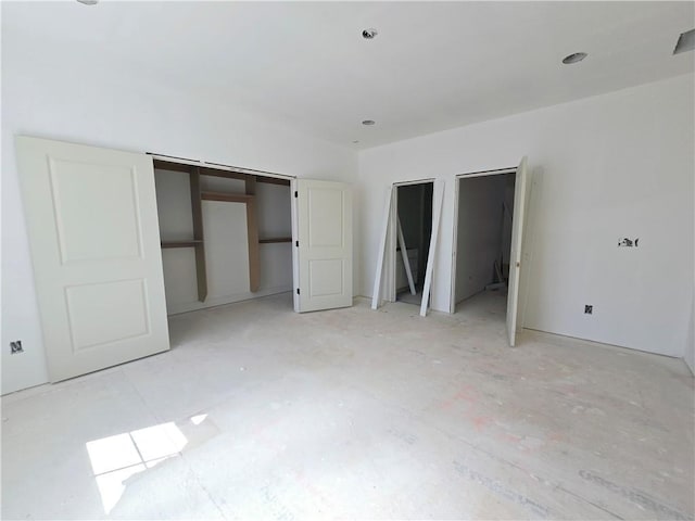 unfurnished bedroom with two closets