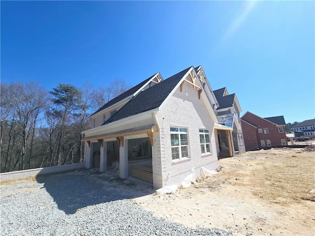 view of side of property featuring a garage and driveway