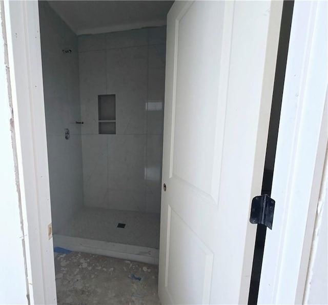 bathroom featuring a shower stall and concrete floors