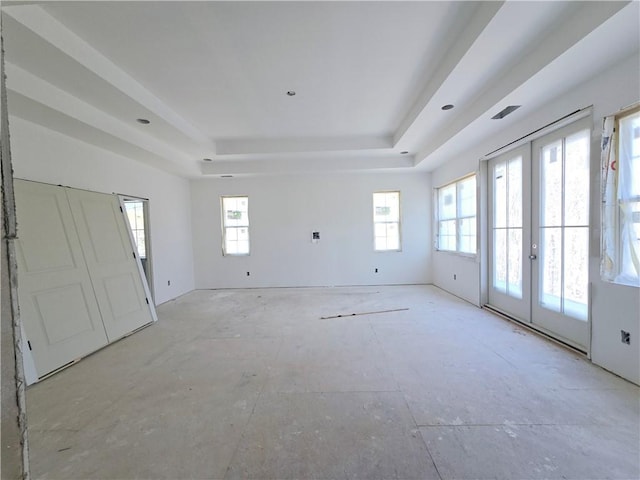 interior space featuring a tray ceiling and french doors