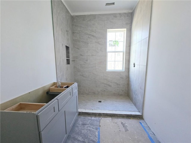 full bath with a tile shower