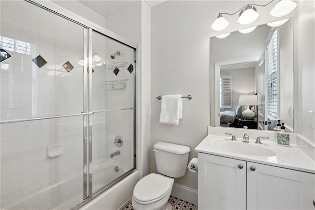 ensuite bathroom featuring vanity, baseboards, shower / bath combination with glass door, toilet, and connected bathroom