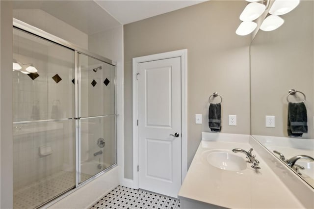 full bathroom featuring vanity, shower / bath combination with glass door, and a chandelier