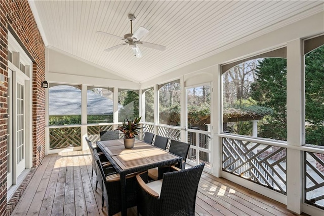 sunroom with vaulted ceiling, plenty of natural light, wood ceiling, and ceiling fan