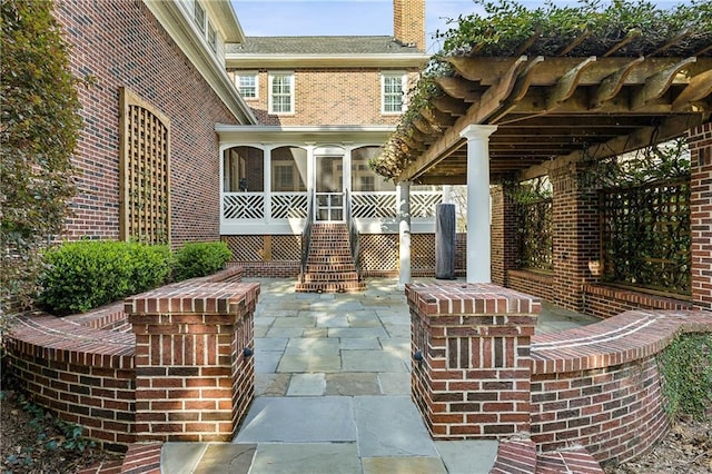 view of patio featuring a sunroom