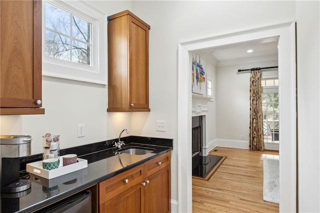 kitchen with a healthy amount of sunlight, brown cabinets, and a sink