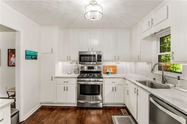 kitchen with sink, white cabinetry, and stainless steel appliances