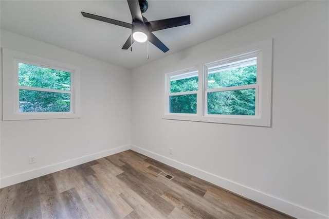 unfurnished room featuring baseboards, a ceiling fan, and wood finished floors