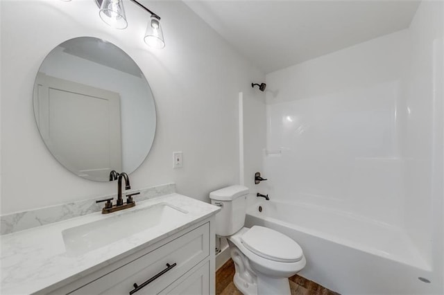 full bath featuring vanity, toilet, shower / washtub combination, and wood finished floors