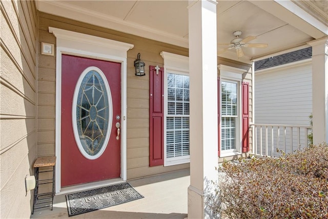 view of exterior entry with covered porch and ceiling fan