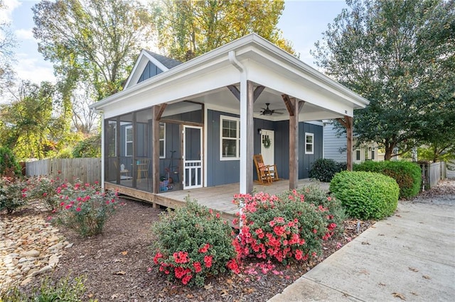 view of front of property featuring a sunroom and ceiling fan