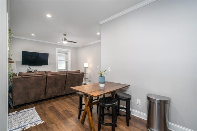 dining space featuring dark hardwood / wood-style floors, ceiling fan, and ornamental molding