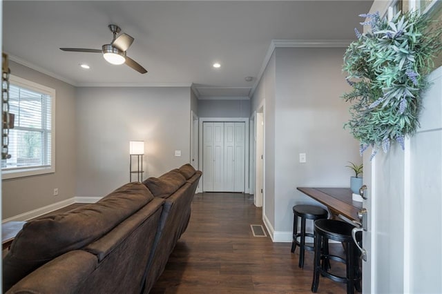 living room featuring crown molding, ceiling fan, and dark wood-type flooring