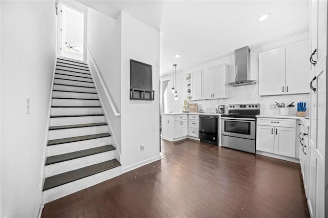 kitchen with dishwasher, electric range, white cabinets, dark hardwood / wood-style flooring, and wall chimney exhaust hood