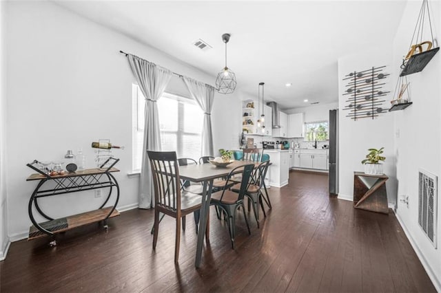 dining space with dark hardwood / wood-style floors