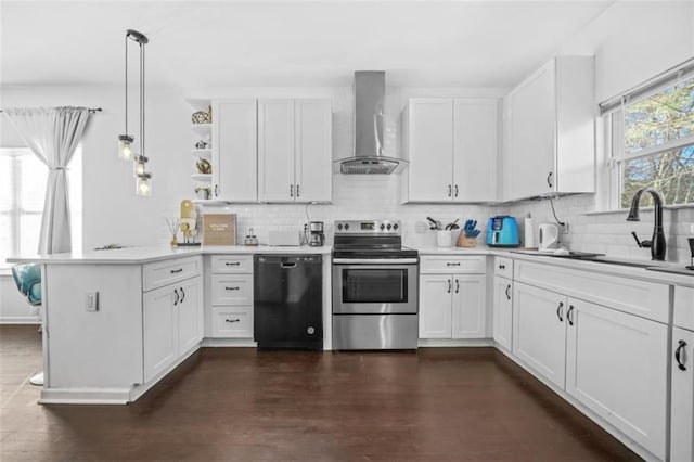 kitchen featuring pendant lighting, dishwasher, electric range, kitchen peninsula, and wall chimney range hood