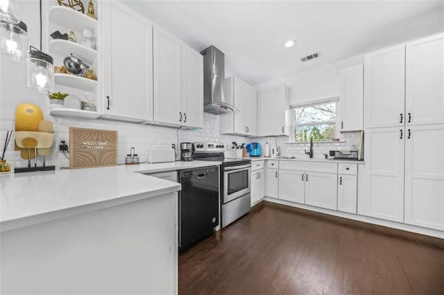 kitchen featuring stainless steel electric range oven, white cabinetry, dishwasher, hanging light fixtures, and wall chimney exhaust hood