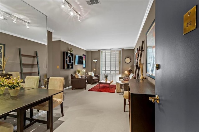 1421 Peachtree St NE Unit 212, Atlanta, GA 30309 - carpeted dining area featuring ornamental molding, track lighting, and baseboards