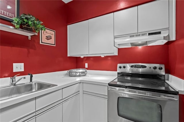 1421 Peachtree St NE Unit 212, Atlanta, GA 30309 - kitchen with stainless steel electric range, under cabinet range hood, light countertops, and white cabinets