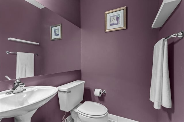 1421 Peachtree St NE Unit 212, Atlanta, GA 30309 - half bathroom with toilet, a sink, and baseboards