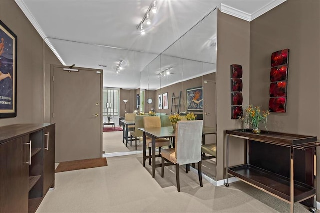 1421 Peachtree St NE Unit 212, Atlanta, GA 30309 - dining space with carpet floors, crown molding, and rail lighting