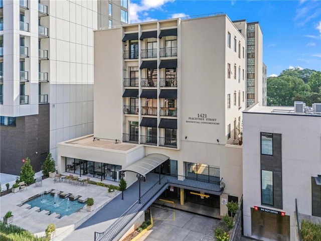 1421 Peachtree St NE Unit 212, Atlanta, GA 30309 - view of apartment building / complex featuring cooling unit and uncovered parking