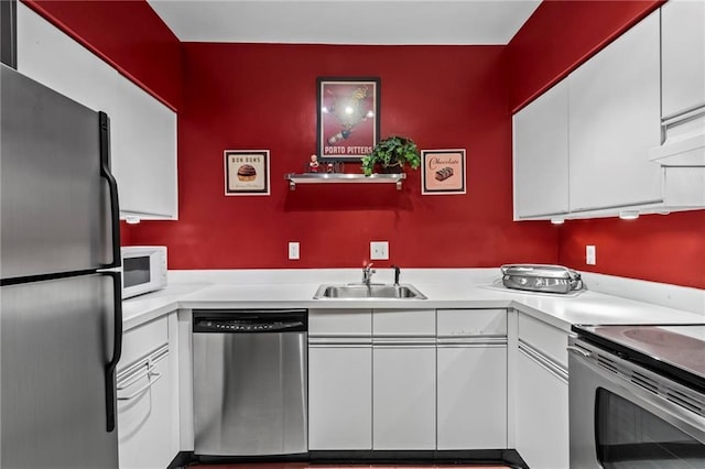 1421 Peachtree St NE Unit 212, Atlanta, GA 30309 - kitchen with appliances with stainless steel finishes, a sink, white cabinetry, light countertops, and under cabinet range hood