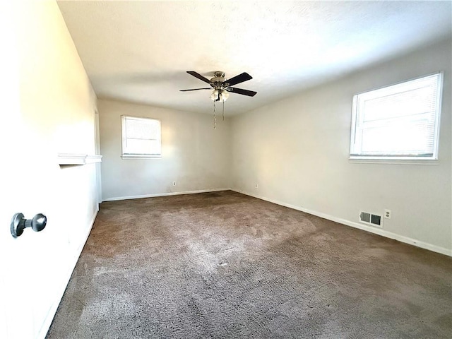 carpeted spare room featuring ceiling fan