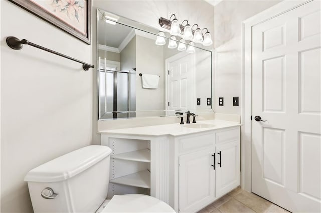 bathroom featuring vanity, tile patterned floors, toilet, and ornamental molding