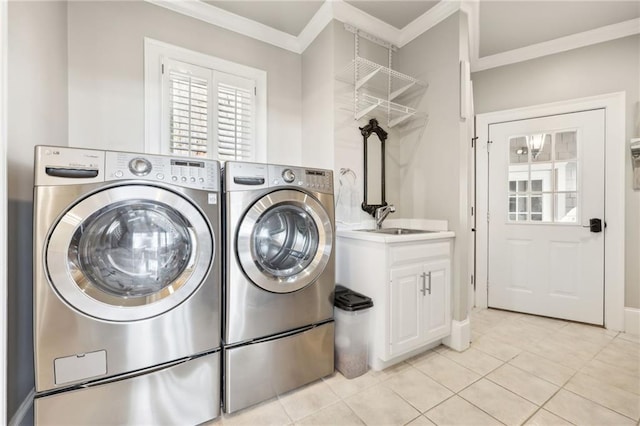 washroom featuring a sink, independent washer and dryer, ornamental molding, and light tile patterned flooring